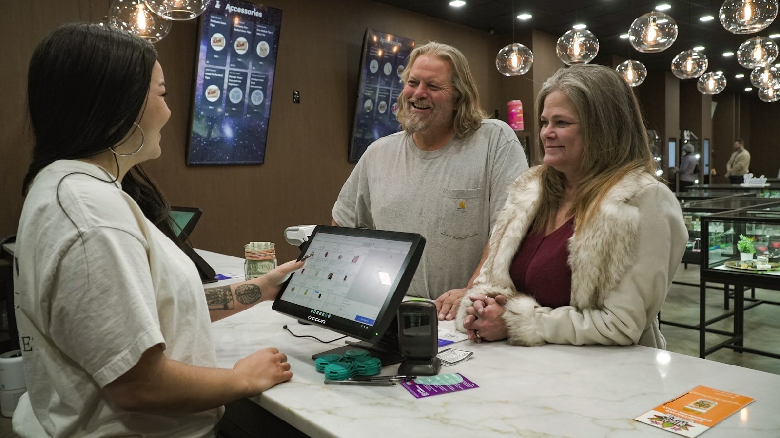 Retail customers interacting at a point-of-sale counter.