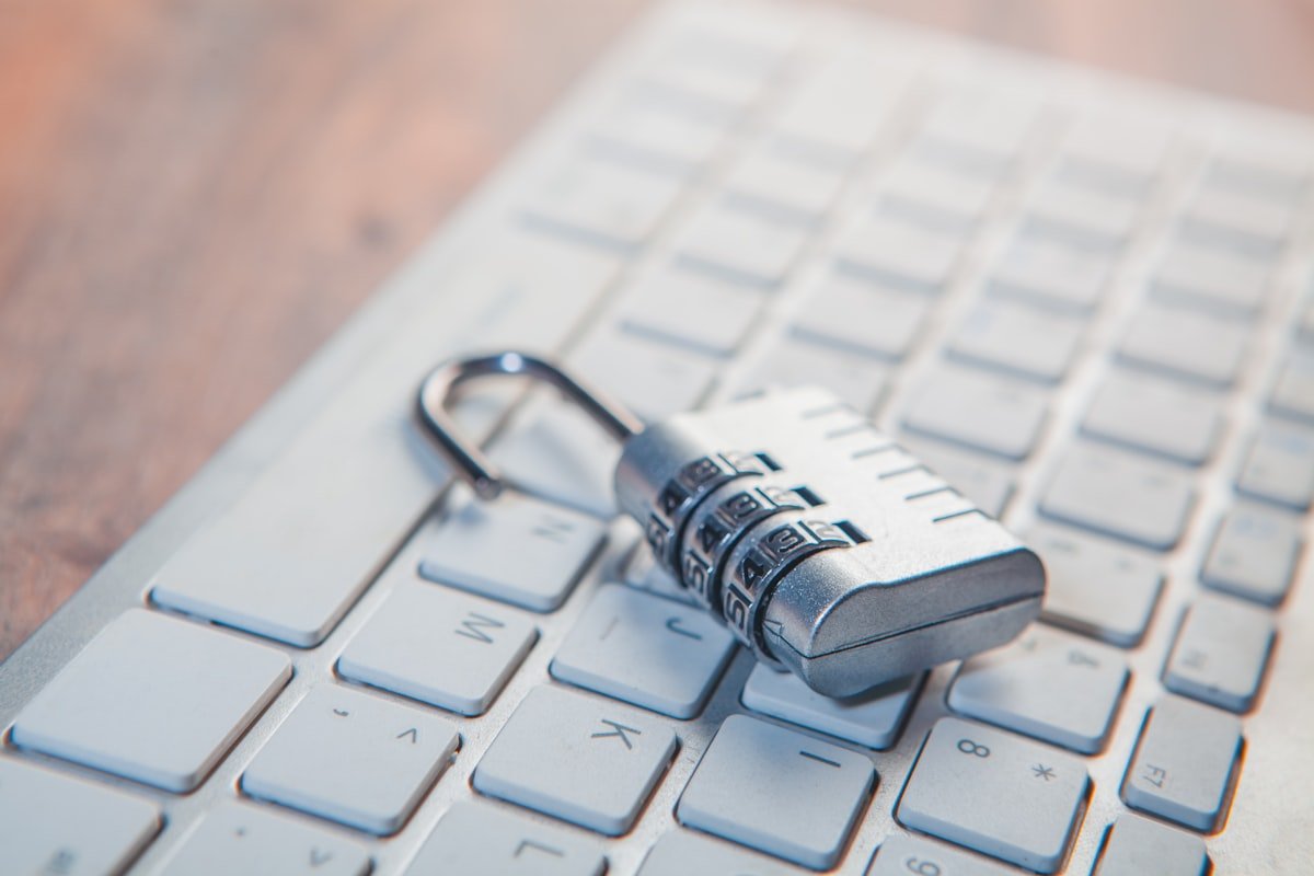 Combination lock resting on a computer keyboard representing cybersecurity.